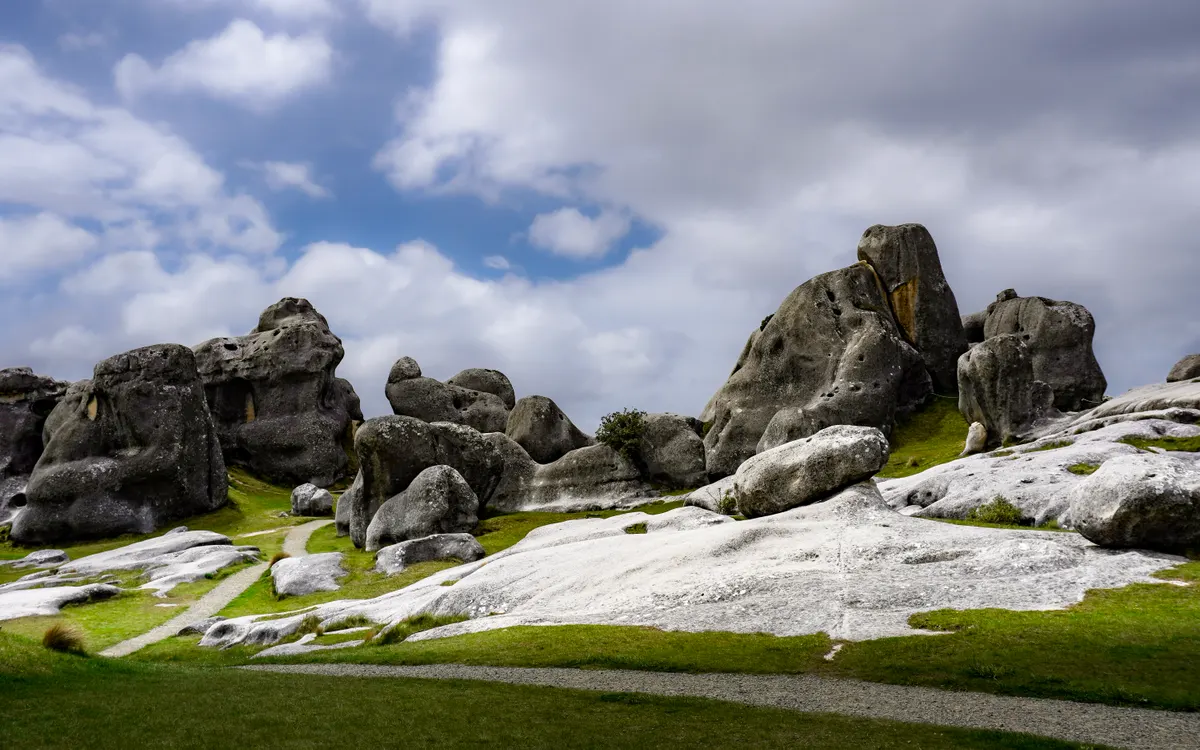 Limestone boulders scattered across the golden tussock of Castle Hill, New Zealand