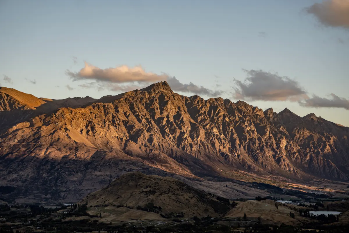 Sunset light on the jagged ridgeline of The Remarkables mountain range near Queenstown