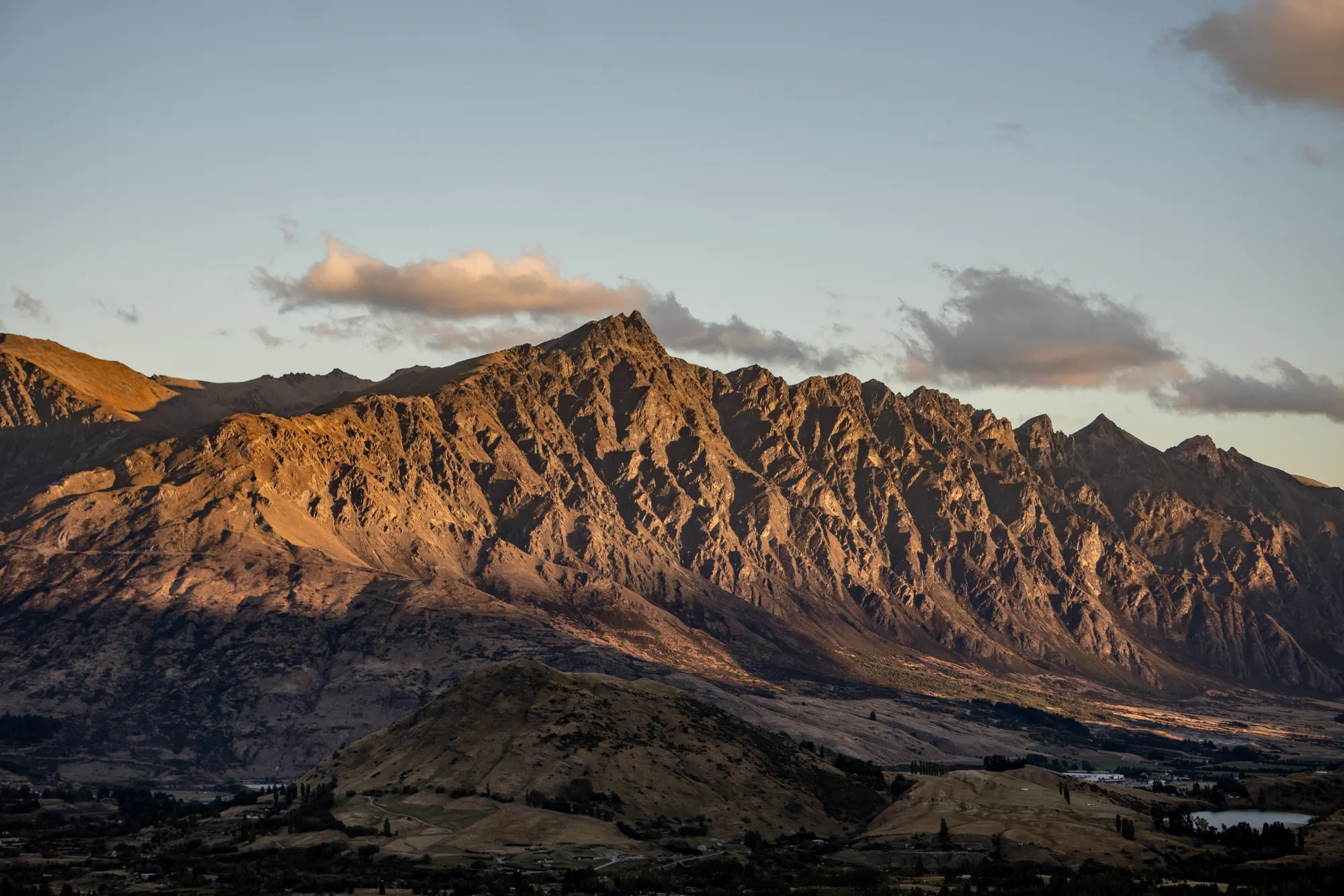 Sunset light on the jagged ridgeline of The Remarkables mountain range near Queenstown