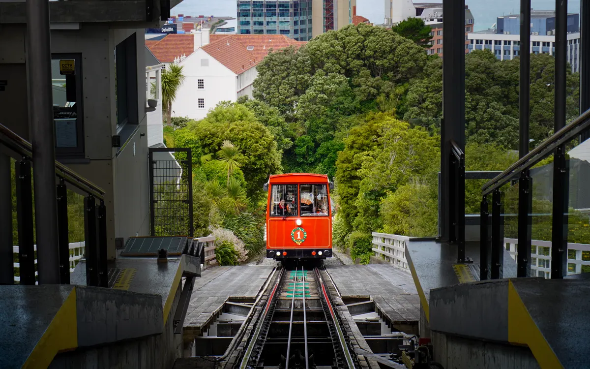 The red Wellington Cable Car climbing above the city at dusk